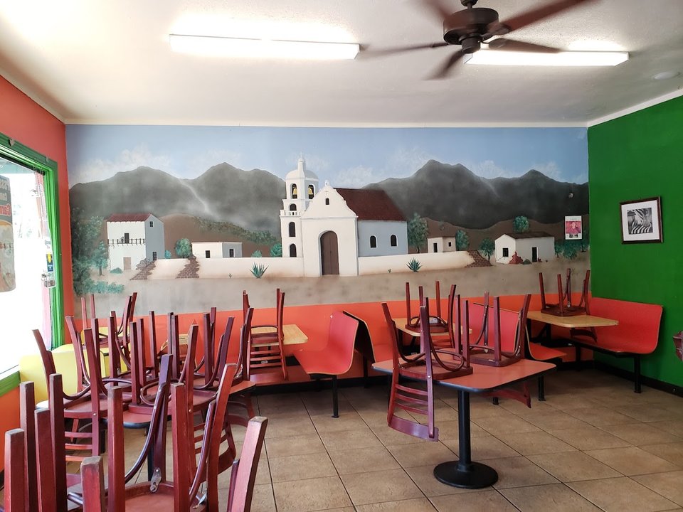 Dining space arranged for groups and solo diners.